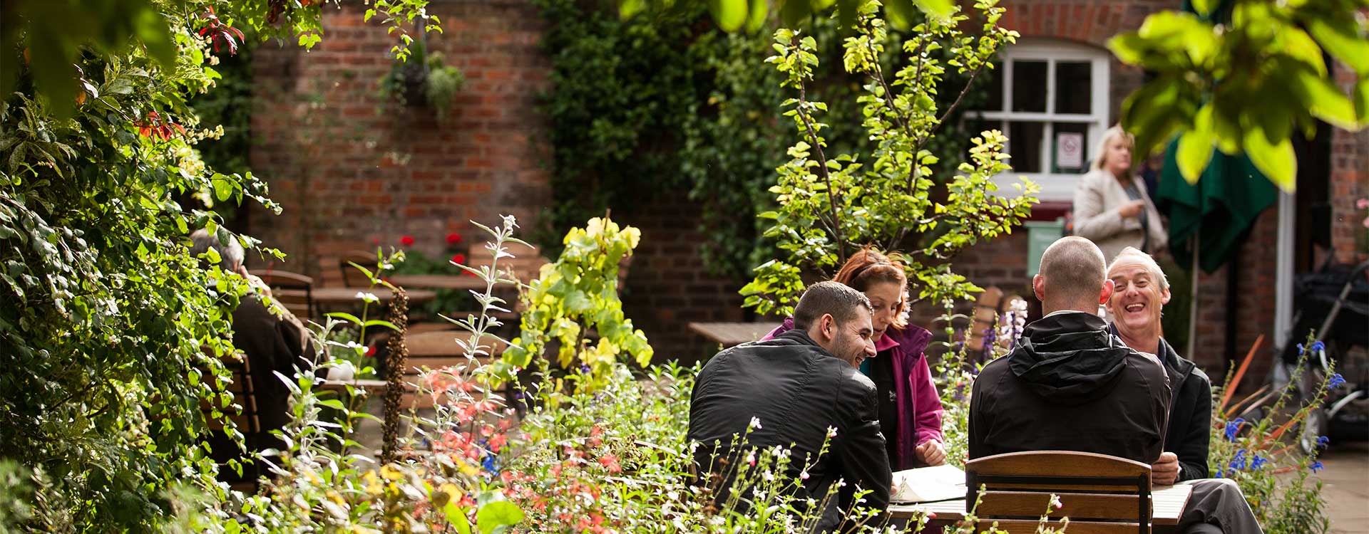 A group of people outside the Garden's Cottage